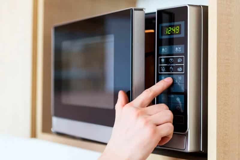 Hand Pressing Microwave Buttons