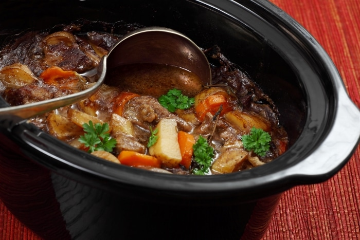 An overfilled slow cooker pot