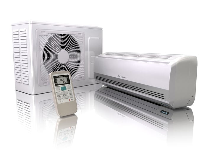 A mini split air conditioner with a remote and an external blower unit