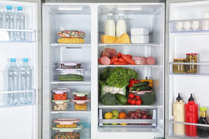 An open fridge full of fresh food