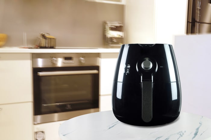 An air fryer and an oven in a wide shot