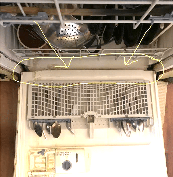 Dishwasher door open showing dirty gasket that may smell