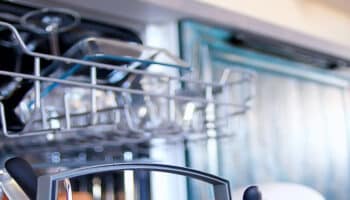 A dishwasher tray loaded with dishes
