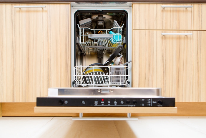 An open dishwasher loaded with dishes