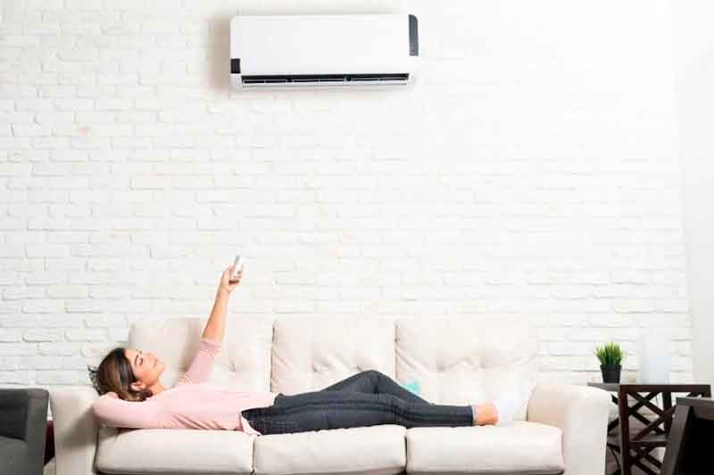 Woman Laid In Couch Using Mini Split AC