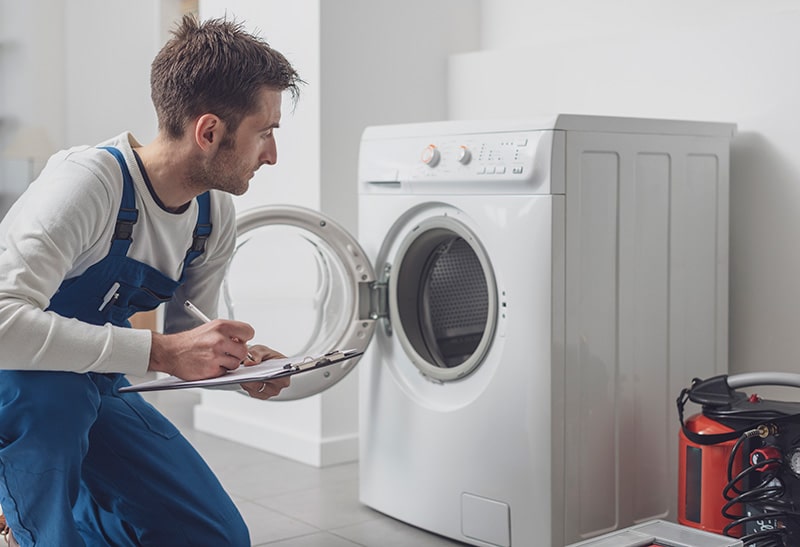 professional inspecting washer
