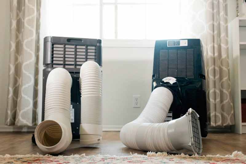 Back view of a portable air conditioner with its ventilation ducts.