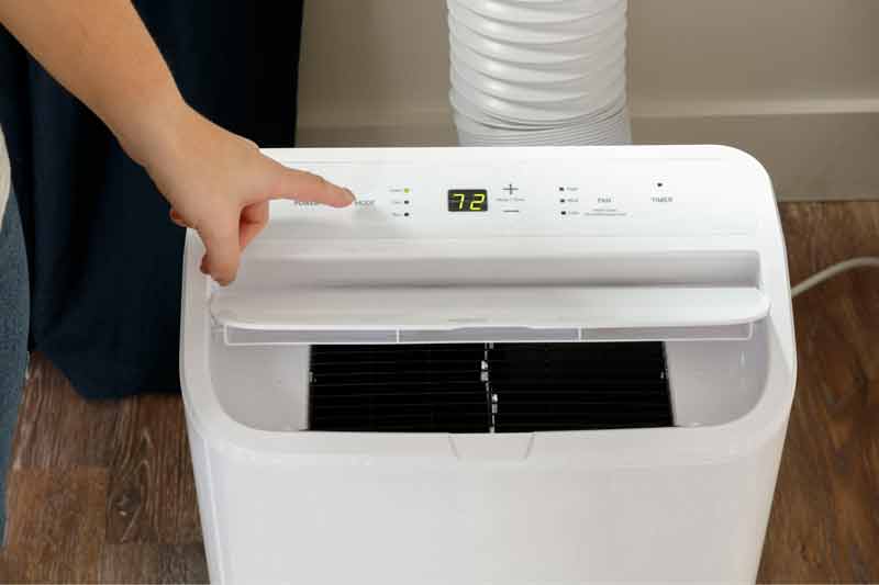 Hand Setting up a portable air conditioner