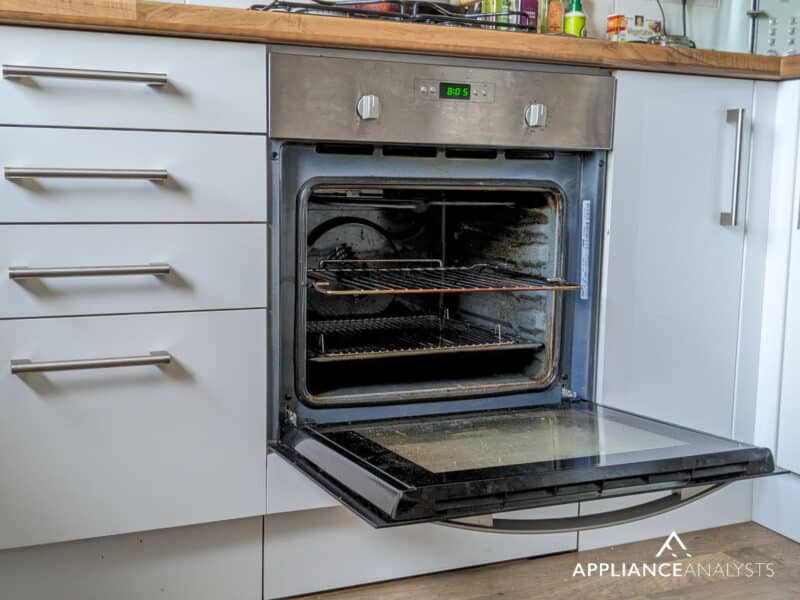 Dirty oven with open door
