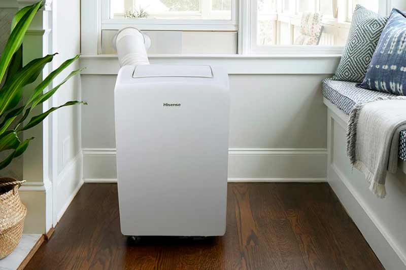 Portable Air Conditioner installed in the bedroom with exhaust duct connected on the window