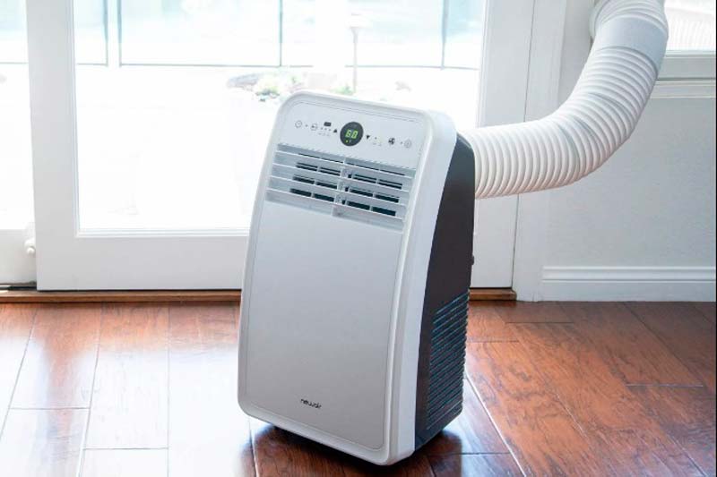 Portable air conditioner installed next to a window