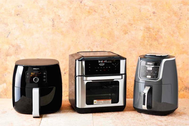 Three air fryers from different brands and different prices arranged side by side