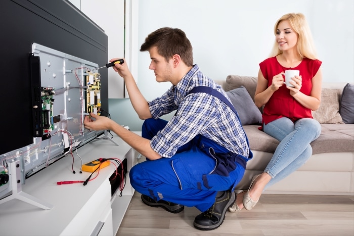 Technician repairing a TV