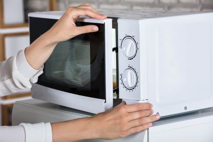 Pushing a microwave's door button
