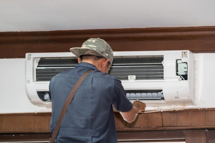 Technician working on an AC unit