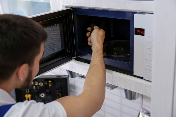 Technician working on microwave