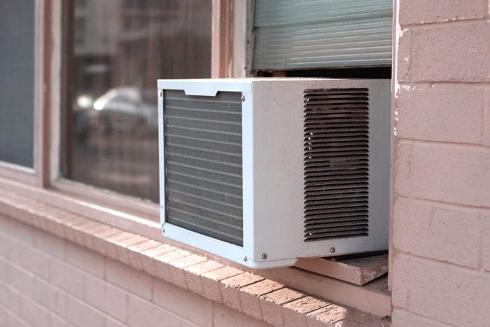 Window AC on brick wall