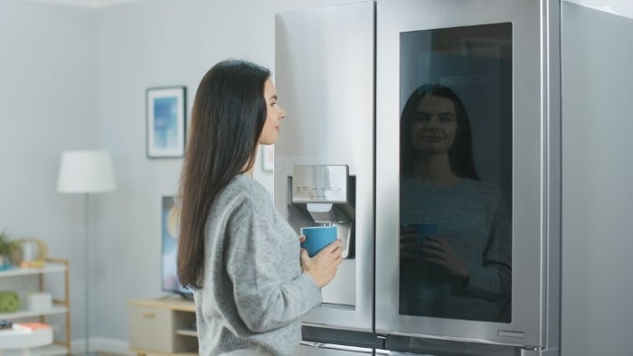 Woman looking at a fridge