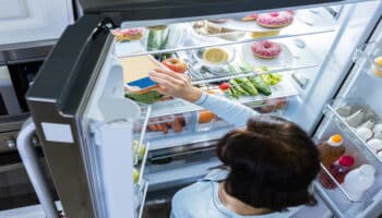 Woman looking inside a fridge